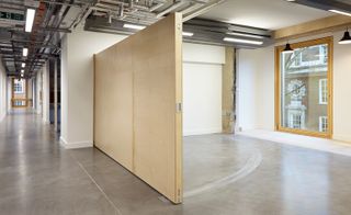 Inside a large open room with a large folding or swinging door