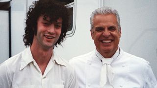 Dominic Sessa on the left, standing with Eric Ripert behind the scenes on the set of Tony