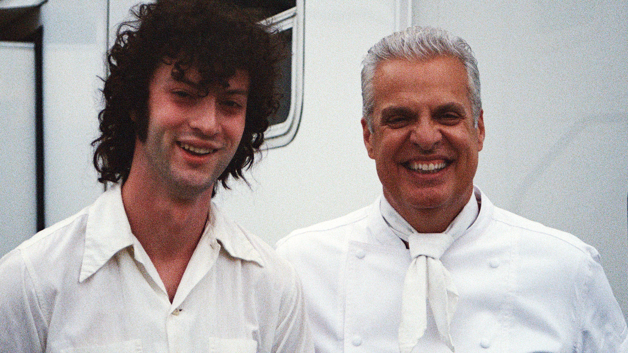 Dominic Sessa on the left, standing with Eric Ripert behind the scenes on the set of Tony