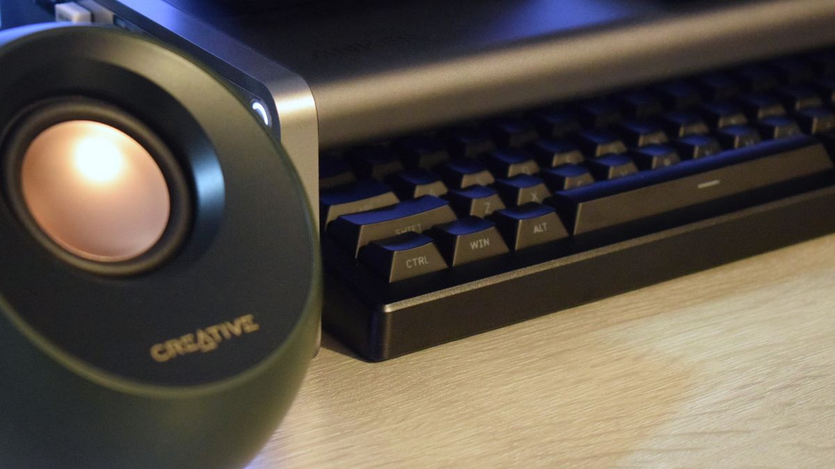 Close-up photo of the Anker 675 USB-C Docking Station showing its storage space filled with a DROP wireless keyboard.