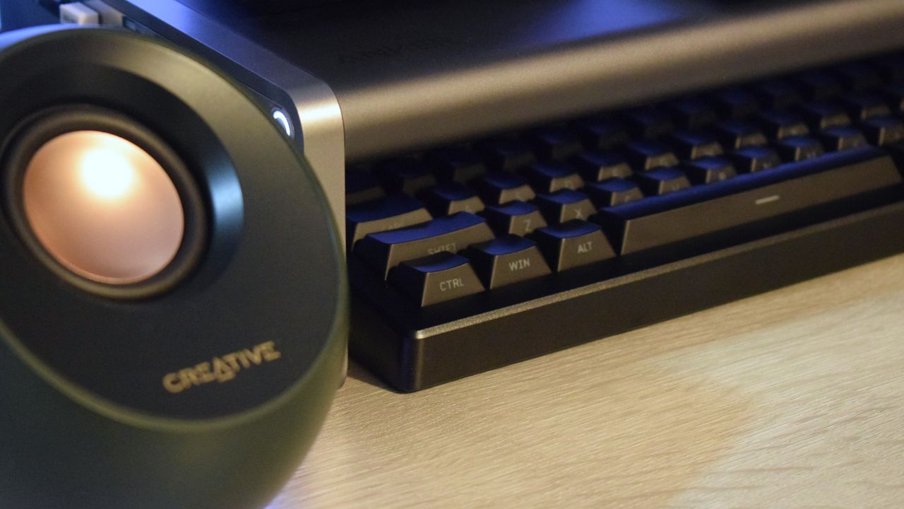Close-up photo of the Anker 675 USB-C Docking Station showing its storage space filled with a DROP wireless keyboard.