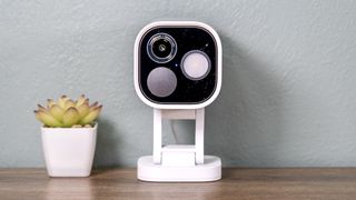 Aqara Camera Hub G5 Pro on a shelf with a small cactus.