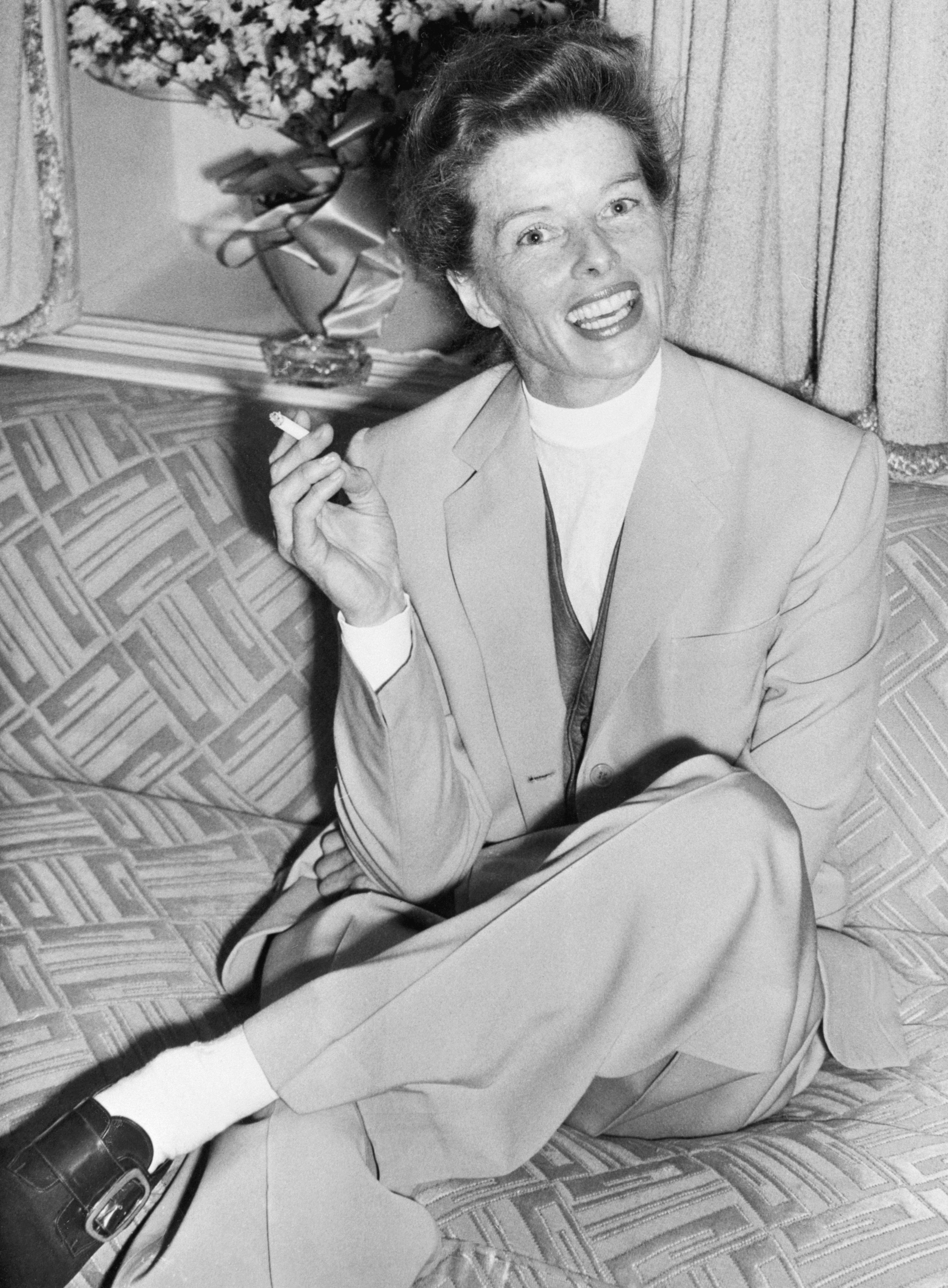 Katharine Hepburn enjoying a cigarette during a press conference in Southampton in 1952.