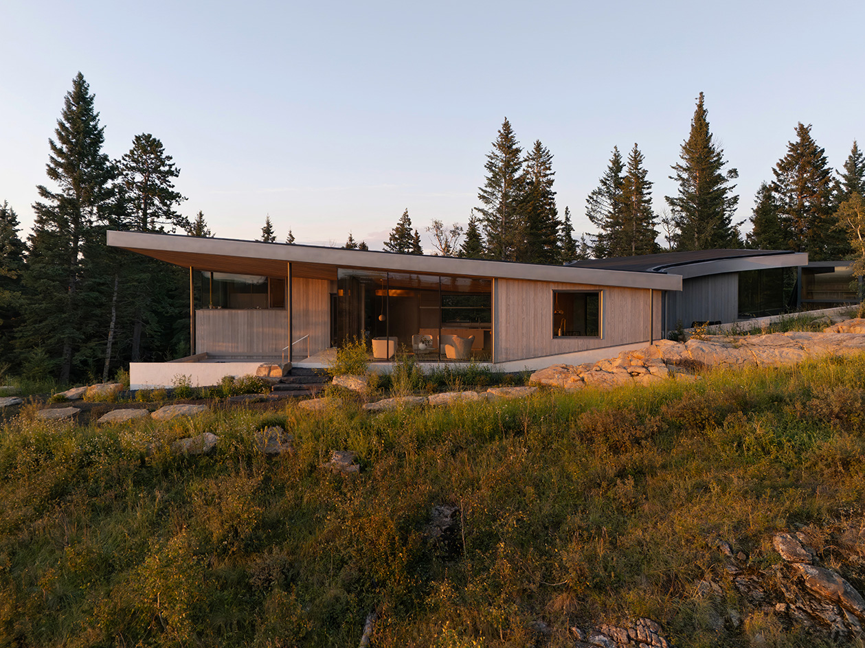 Cut Out House, a square footprint home with a round cut out set in the canadian winderness, by a lake