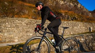 Cyclist climbing on the road wearing rh+ kit