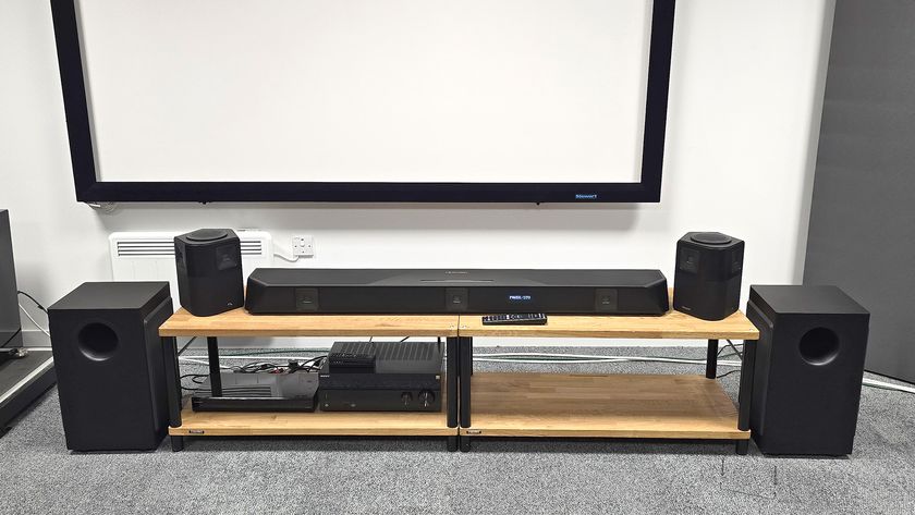 Nakamichi Dragon soundbar system and surrounds on wooden rack with subwoofers on floor to side