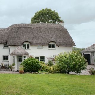 White cottage with thatched roof