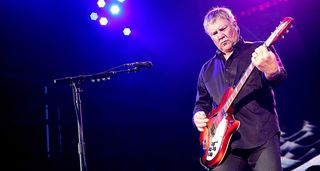 Alex Lifeson performs onstage with Rush in 2015, playing his 1966 Rickenbacker 365 in a Fireglo finish.