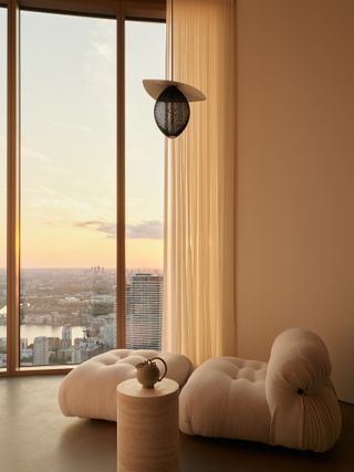 chair in front of window, view on london, from One Park Drive penthouses