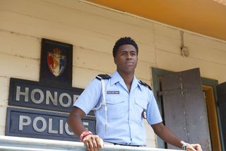 Tobi leaning on the balcony at Honore Police Station