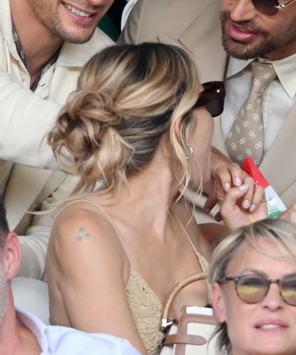 Sienna Miller, wearing Ralph Lauren, attends day fourteen of the Wimbledon Tennis Championships at the All England Tennis and Croquet Club at on July 13, 2025 in London, England