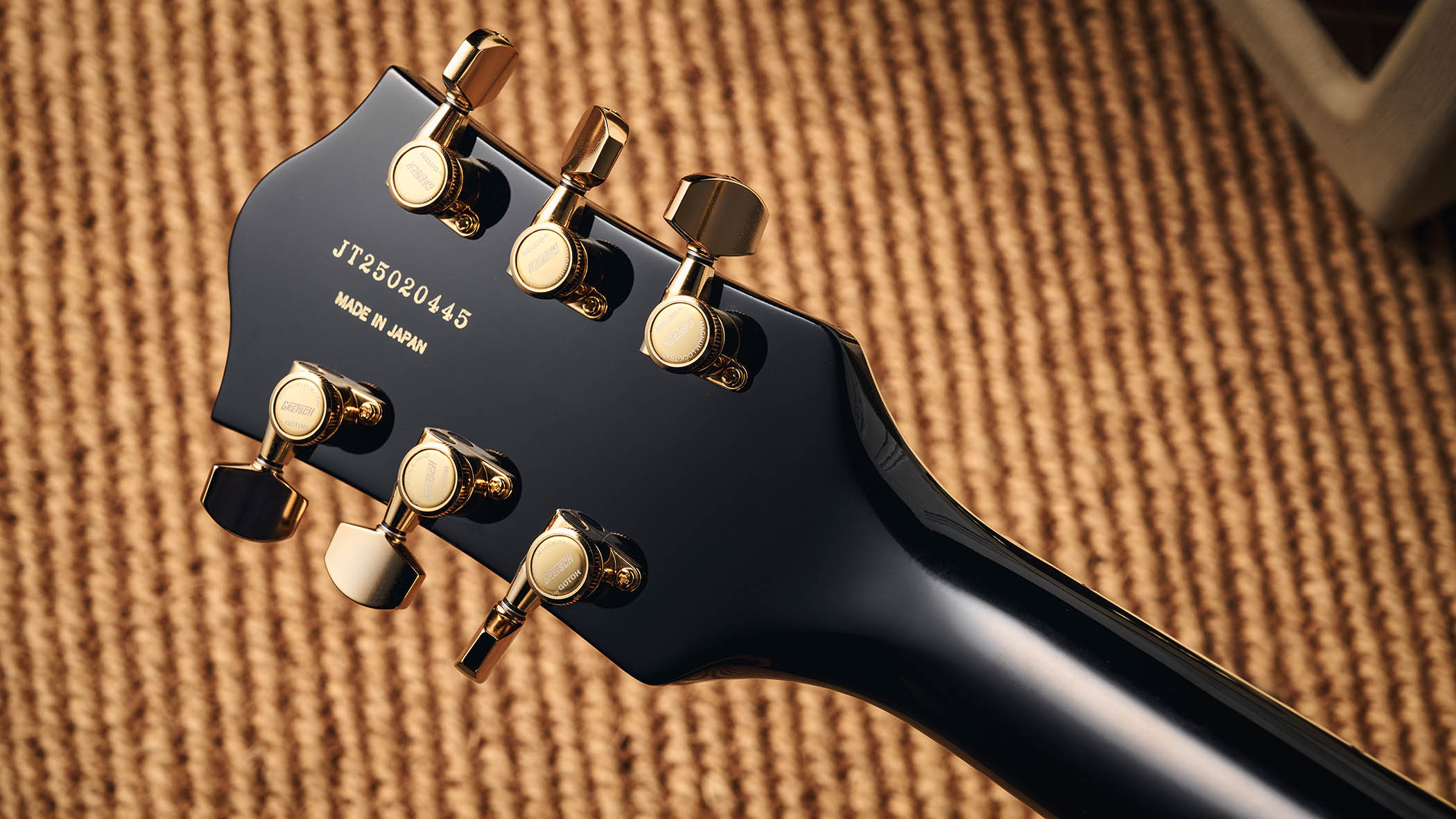 Gretsch Professional Collection Broadkaster LX Center Block: the handsome semi-hollow is finished in black with gold hardware and here is photographed in close-up.
