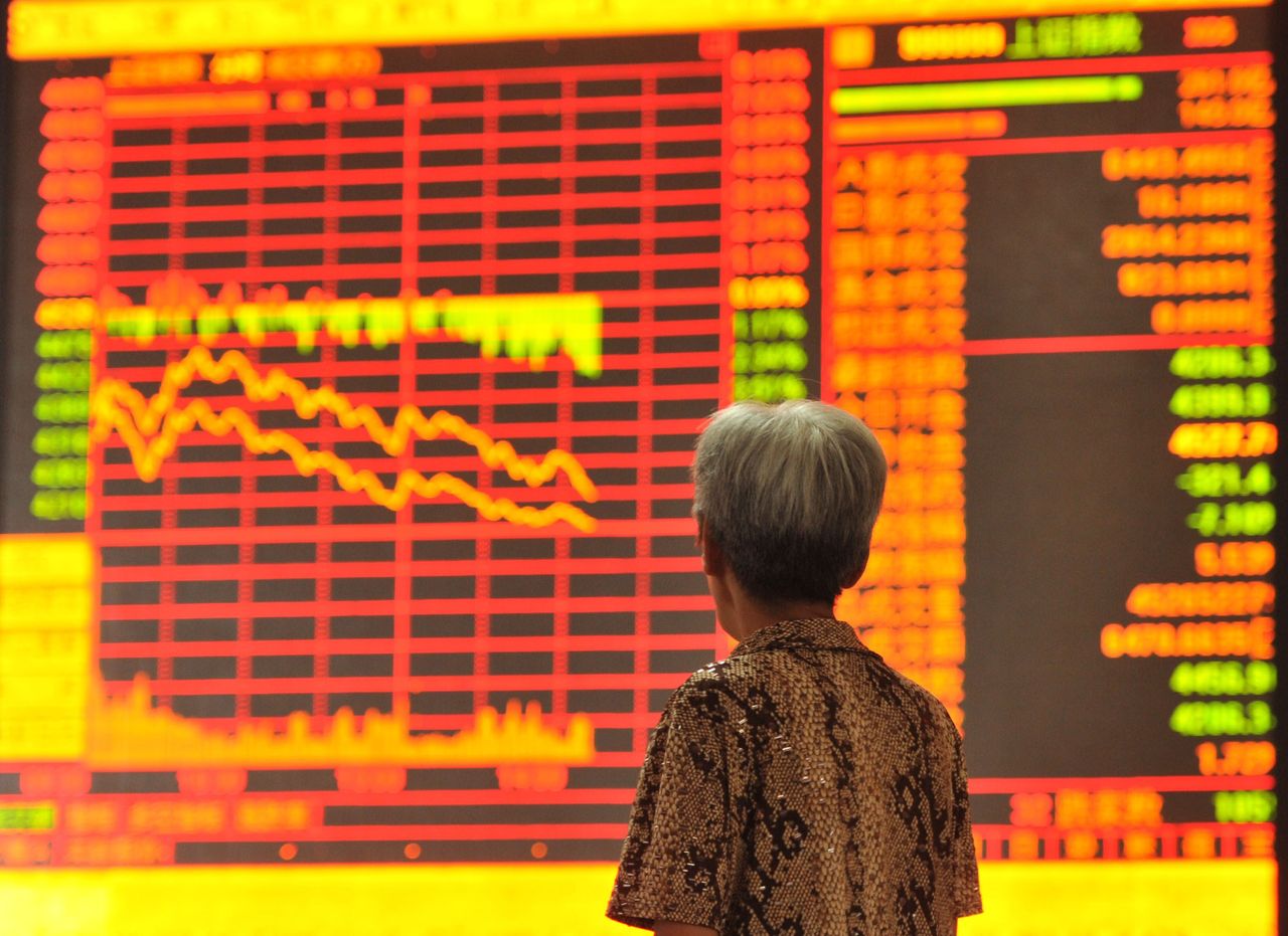 A Chinese investor checking share prices in a stock firm 