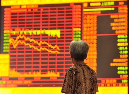 A Chinese investor checking share prices in a stock firm 