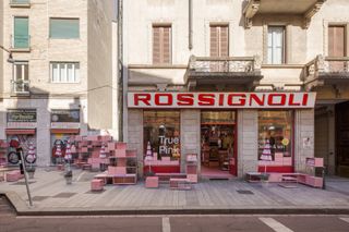 Pink USM Haller furniture installation outside Rossignoli shop in Milan
