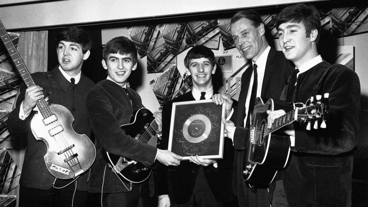 The Beatles and George Martin with the silver disc which they have been awarded after selling 1/4 million copies of their hit single Please Please Me.