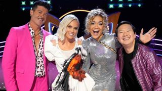 Panelists Robin Thicke, Jenny McCarthy-Wahlberg, Rita Ora and Ken Jeong pose in a promotional shot for The Masked Singer season 11