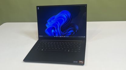 A Razer Blade 14 (2025) on a desk showing the Windows 11 desktop
