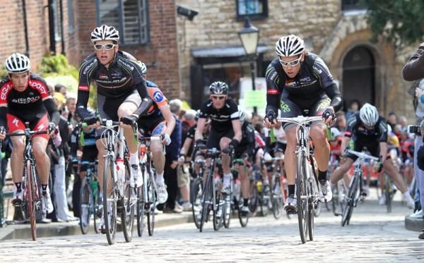Endura teammates Rob Partridge and Alexandra Blain lead the field up the steep climb by the cathedral.
