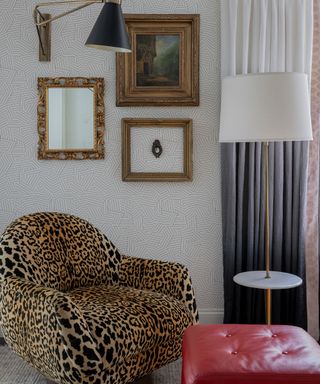 Leopard print chair, red footstool, white lampshade