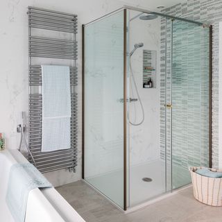 white tiles bathroom with glass partition for shower area