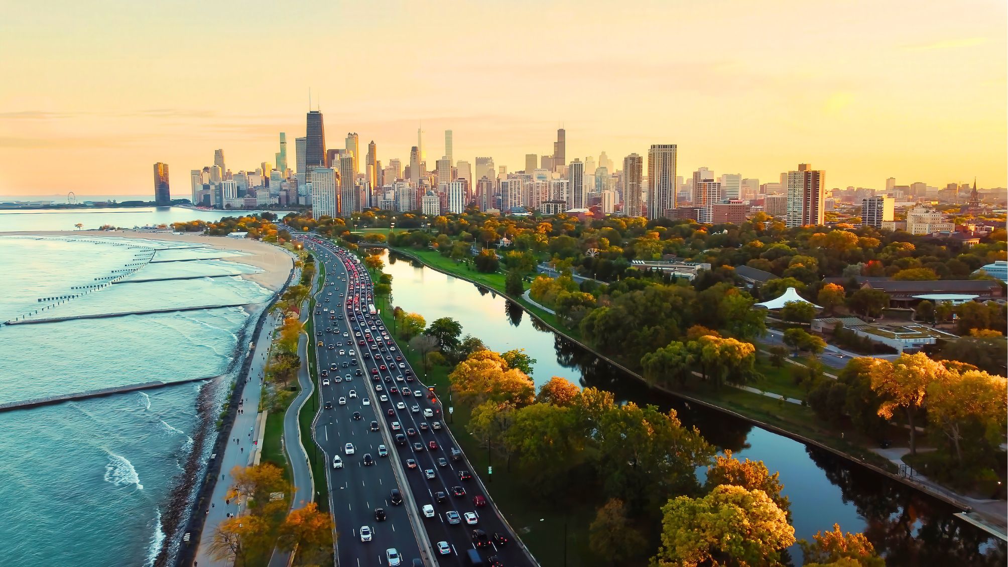 Aerial view of Chicago skyline at sunset, showing Lake Michigan shoreline