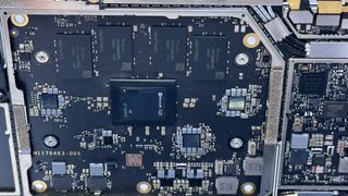 Closeup of Microsoft SQ3 chip on the mainboard of the Surface Pro 9 5G tablet.