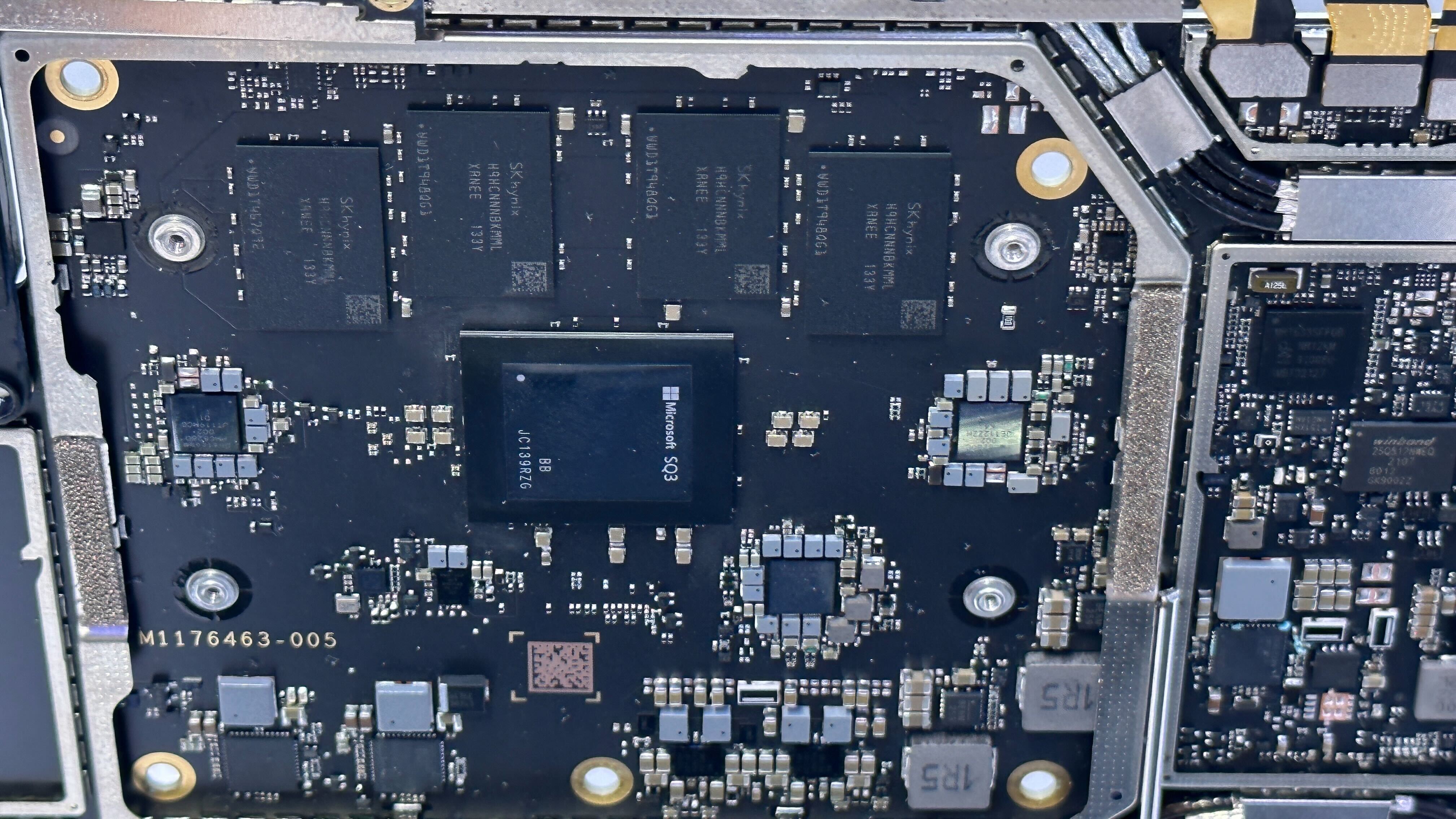 Closeup of Microsoft SQ3 chip on the mainboard of the Surface Pro 9 5G tablet.