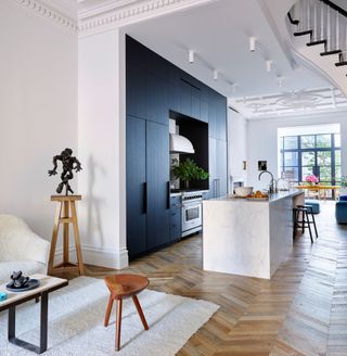 Navy blue one wall kitchen with white walls open plan NYC apartment