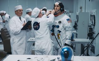 NASA technicians help Neil Armstrong (Ryan Gosling) into his Apollo 11 spacesuit in this scene from the movie "First Man."