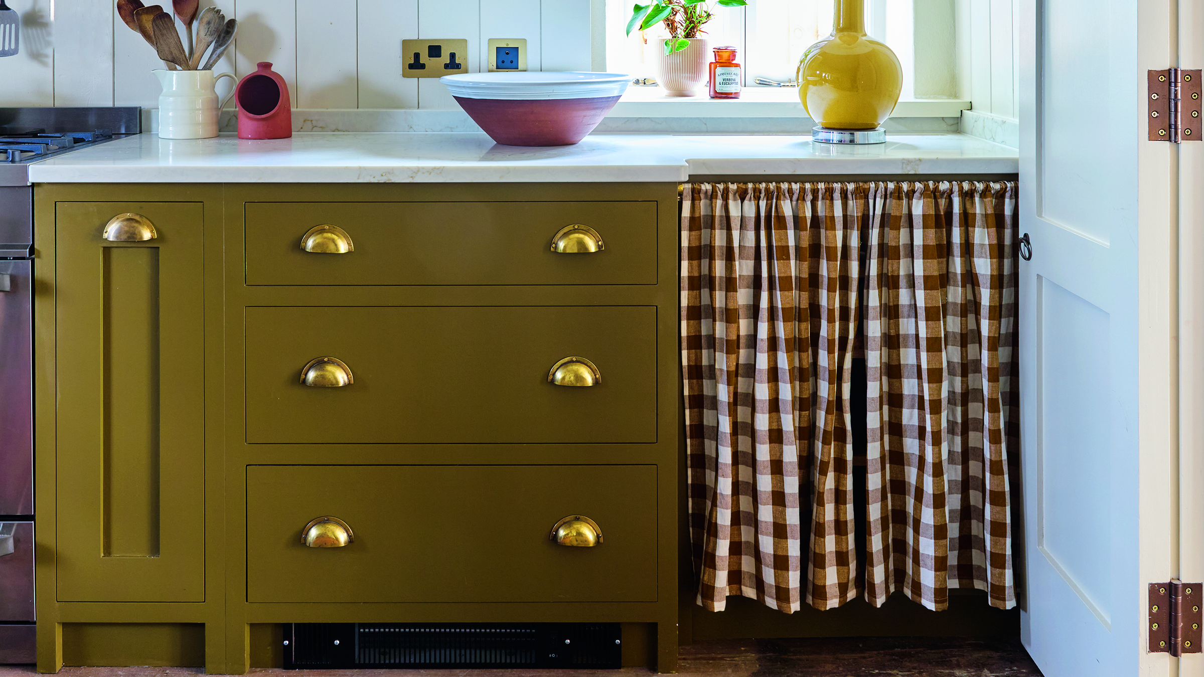 Olive green kitchen with gingham cafe curtain