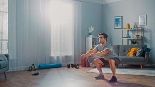 a photo of a man doing a bodyweight squat
