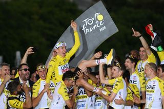 Tadej Pogačar and his UAE Team Emirates team-mates celebrate his victory at the Tour de France 2024.