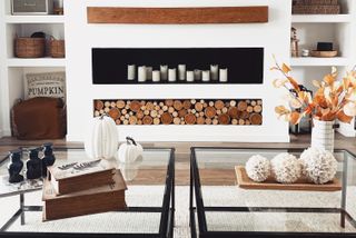 A living room with fake fireplace made with candles