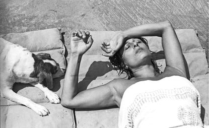 A woman lying on the floor with her dog