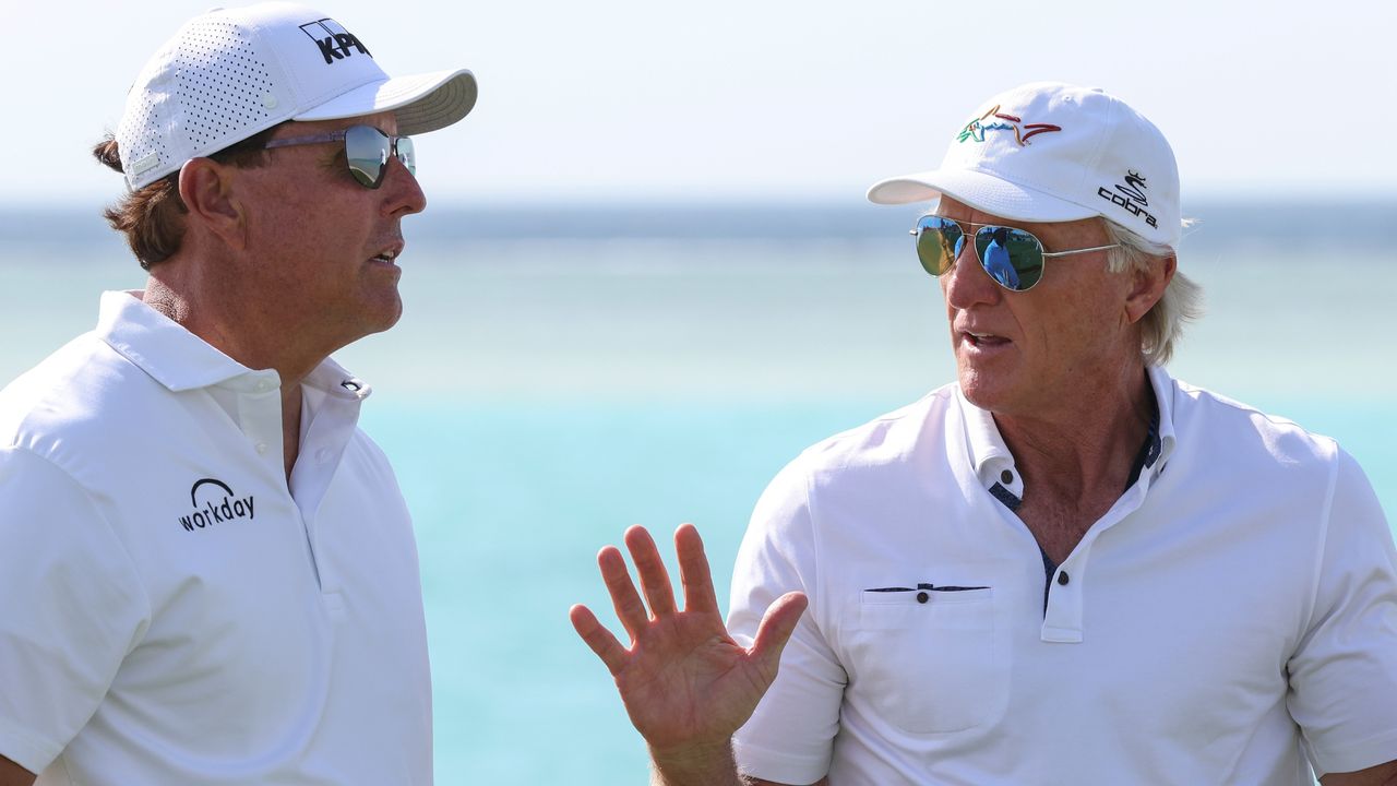 Phil Mickelson and Greg Norman talk before the 2022 PIF Saudi International