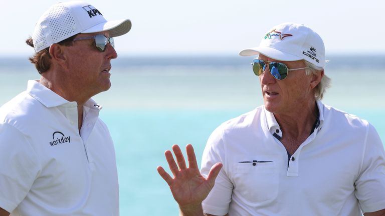 Phil Mickelson and Greg Norman talk before the 2022 PIF Saudi International