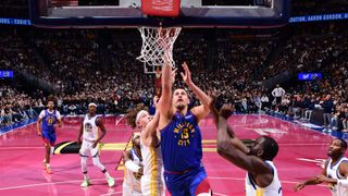 Nikola Jokic driving to the basket in a recent Nuggets vs Warriors game