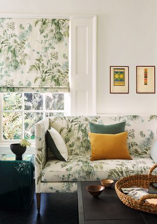An example of small living room decor ideas where the leaf pattern on the sofa matches the window blind.