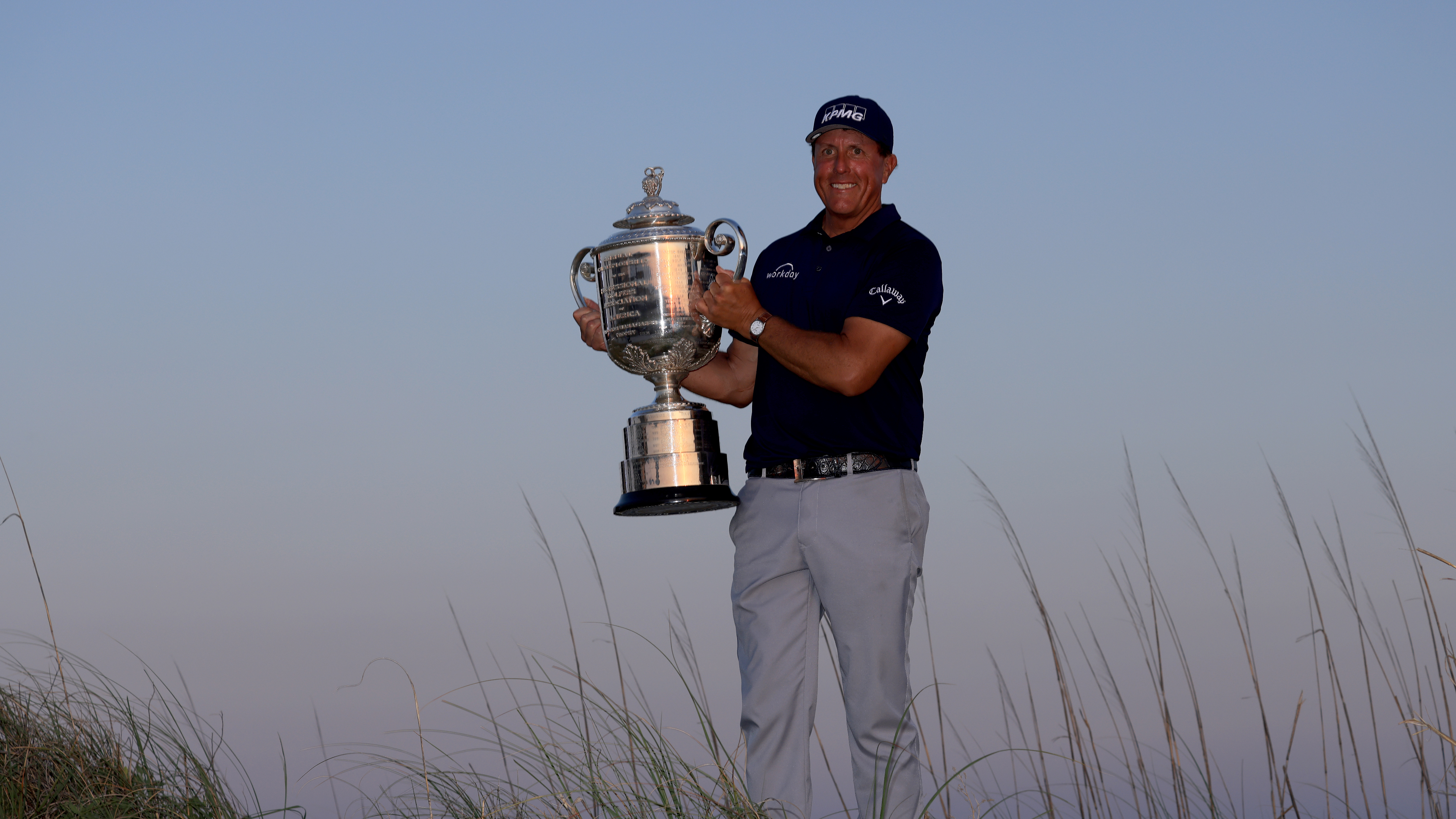 Phil Mickelson holding the USPGA Championship trophy after winning in 2021