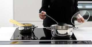 cooking pasta on a n induction hob vs electric hob to show how much more energy efficient induction is
