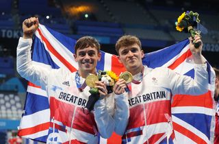 Thomas Daley and Matty Lee of Team Great Britain pose for photographers with their gold medals after winning the Men's Synchronised 10m Platform Final