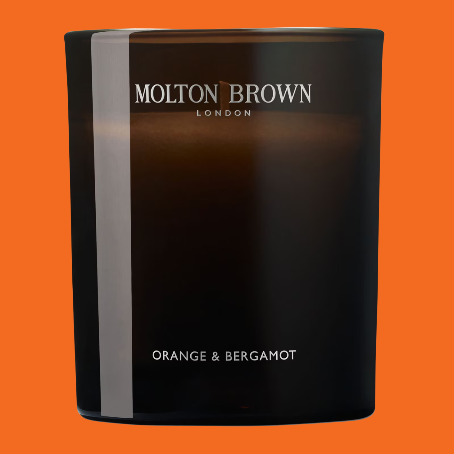 A scented candle in a brown vessel