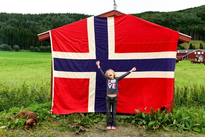 A young fan awaits the Arctic Race of Norway peloton to pass by