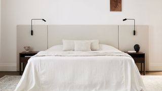 modern and netural bedroom with bed made with Culitver linen sheets