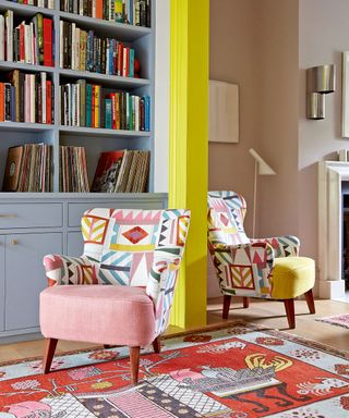 Colorful living room with blue bookcase and patterned rug