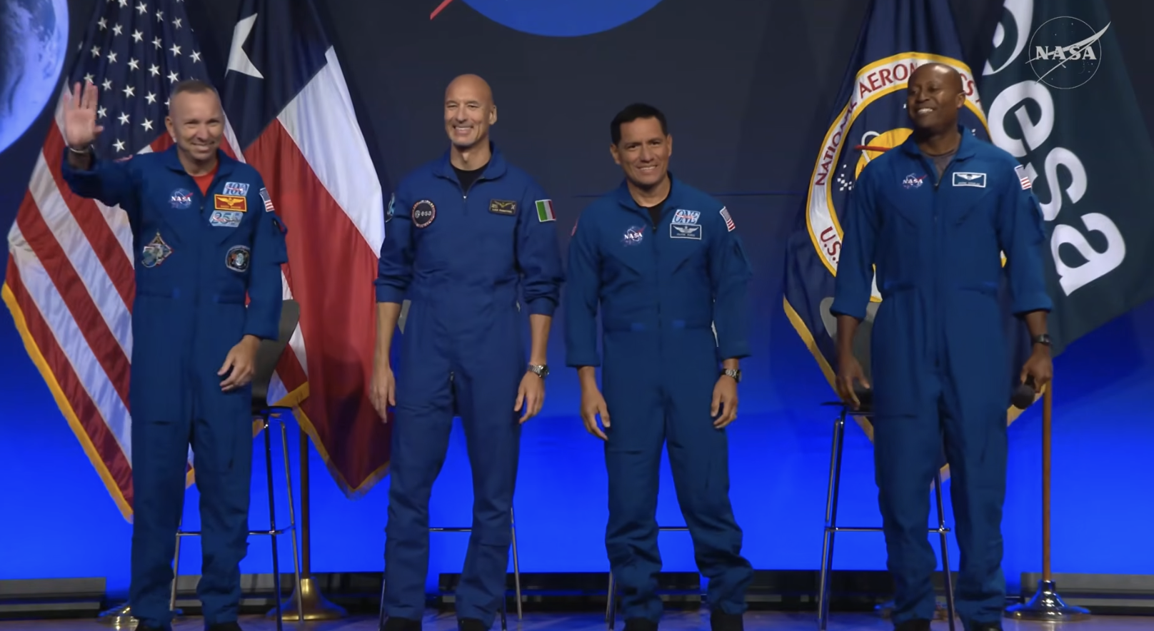 The Artemis III astronauts pose onstage