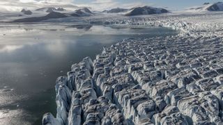 Aerial view of glaciers in Svalbard and Jan Mayen. The pictures shows the edge of the glacier close to the sea.