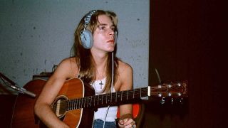 Randy Rhoads playing an acoustic guitar in the studio
