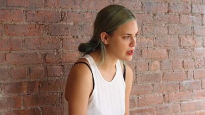 Brick, Hairstyle, Shoulder, Eyebrow, Sleeveless shirt, Wall, Photograph, Joint, Brickwork, Style, 